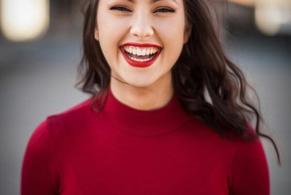 Confident woman smiling, representing a positive work environment and effective job descriptions in Colorado hiring practices.
