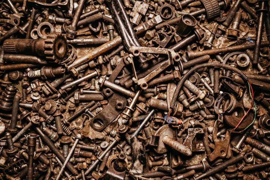 A collection of bolts, gears, and mechanical parts symbolizing how systemic HR connects different components of a business for seamless operation.
