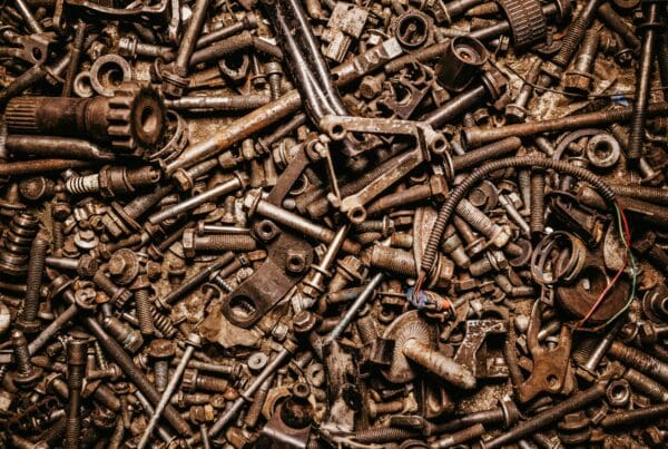 A collection of bolts, gears, and mechanical parts symbolizing how systemic HR connects different components of a business for seamless operation.